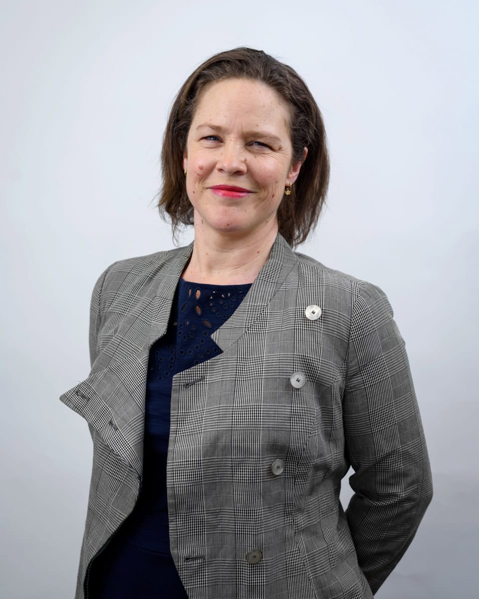 a LinkedIn headshot showing a woman in corporate clothing with brown hair taken by Molly Rhianon photography
